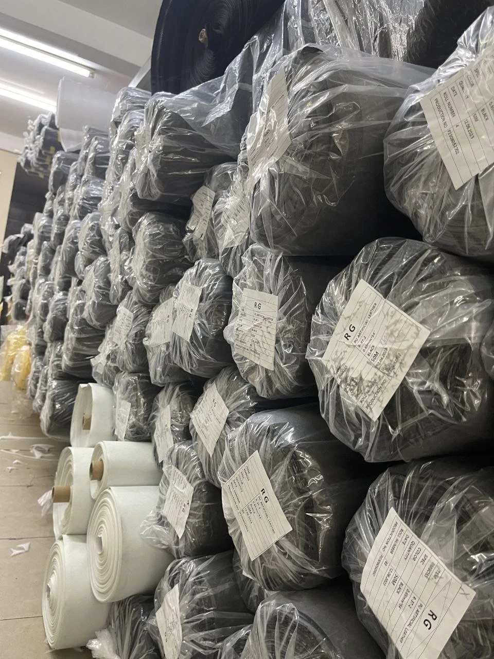 Stacked material rolls in clear wrapping